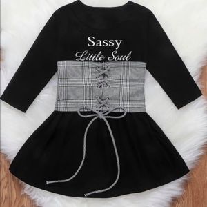 Black toddler dress with white and black corset belt with word sassy